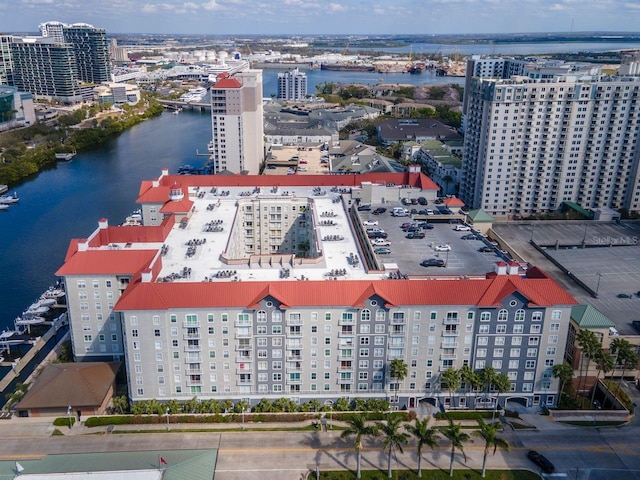 birds eye view of property with a water view and a city view