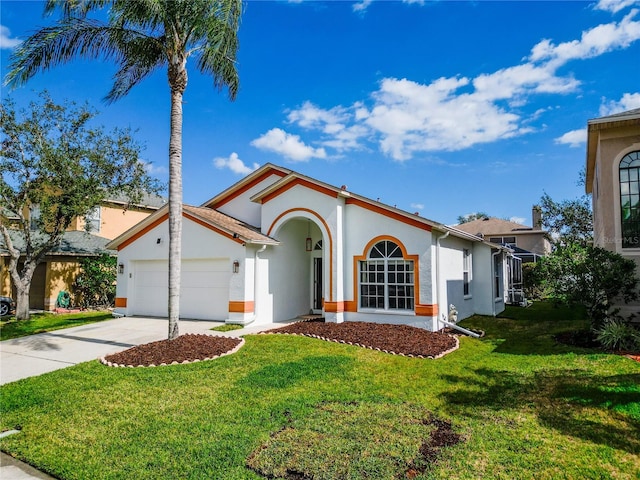 mediterranean / spanish-style home with a garage and a front yard