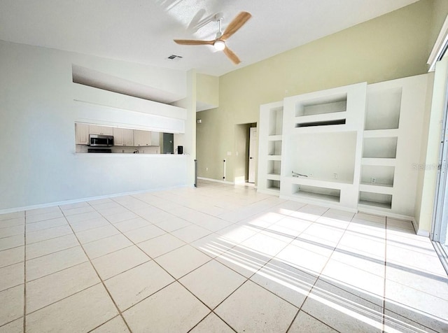1609 Shady Oaks Dr, Oldsmar, FL 34677 - unfurnished living room featuring tile patterned flooring, ceiling fan, built in features, baseboards, and lofted ceiling