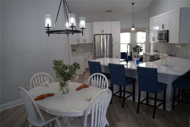 dining space with sink and dark hardwood / wood-style flooring