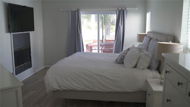 bedroom with dark hardwood / wood-style floors