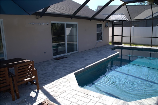 view of pool with a patio and glass enclosure