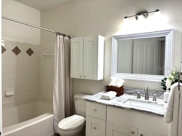 full bathroom featuring vanity, shower / tub combo, and toilet