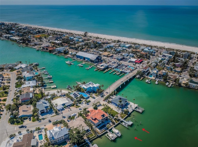 birds eye view of property featuring a beach view and a water view