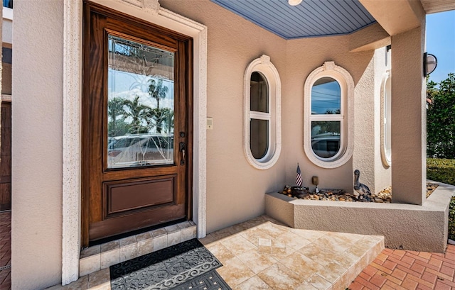 entrance to property featuring stucco siding