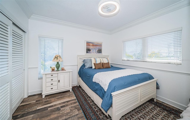 bedroom with baseboards, dark wood-type flooring, and crown molding