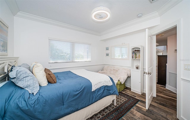 bedroom with crown molding, visible vents, and dark wood-style flooring