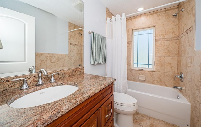 bathroom featuring toilet, shower / bath combo, and vanity