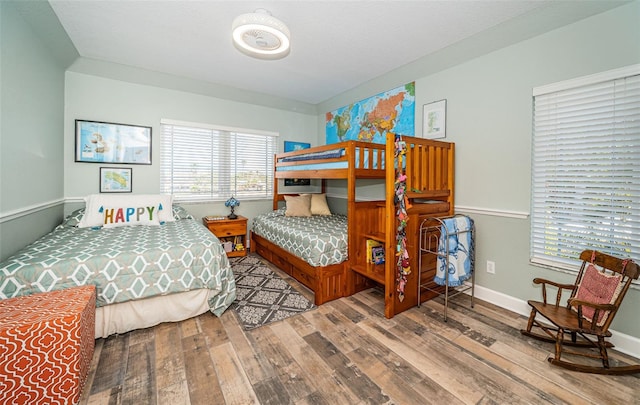 bedroom with baseboards and wood finished floors