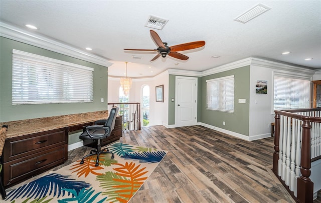 office area with ornamental molding, dark wood-style flooring, built in desk, and visible vents