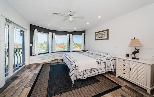 bedroom featuring access to outside, multiple windows, visible vents, and dark wood-style flooring