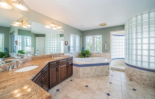 bathroom featuring a bath, double vanity, a sink, and tile patterned floors