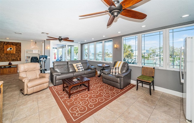 living area with recessed lighting, visible vents, light tile patterned flooring, a textured ceiling, and baseboards