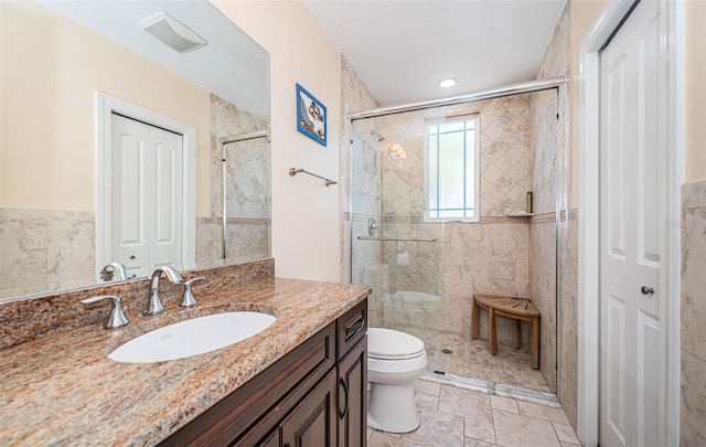 full bathroom with a closet, visible vents, toilet, a stall shower, and vanity