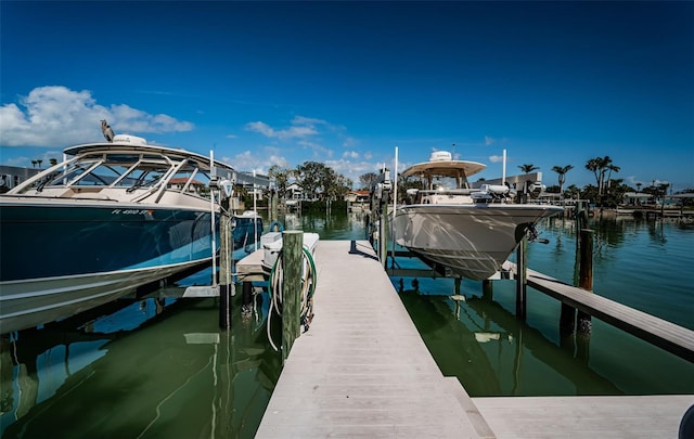 dock area with a water view and boat lift