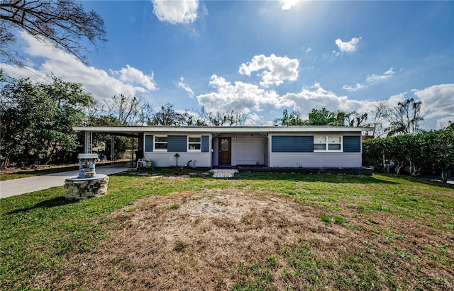 view of front of house with a front lawn and a carport