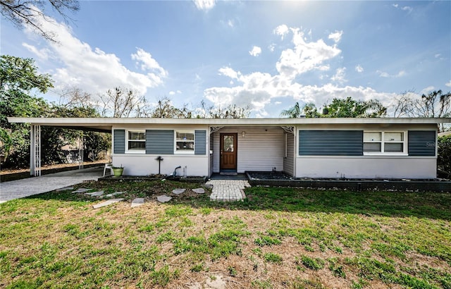 single story home with a front lawn and a carport