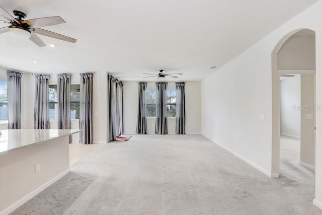 spare room with light carpet and ceiling fan