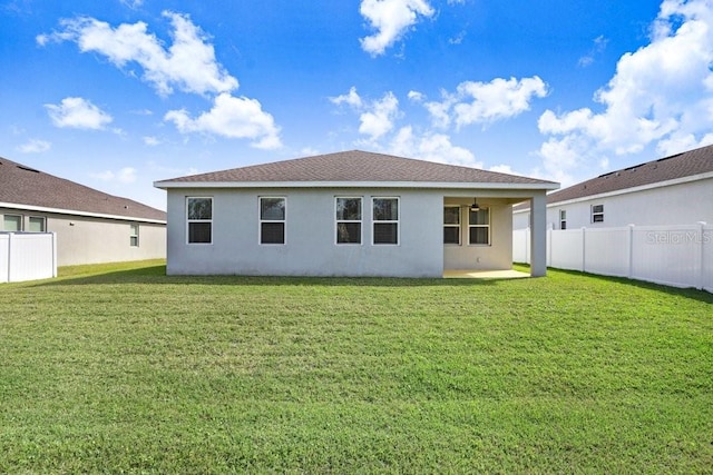 back of house with a yard and a patio area