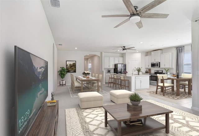 6307 113th Ter E, Parrish, FL 34219 - living room with arched walkways, a ceiling fan, and recessed lighting