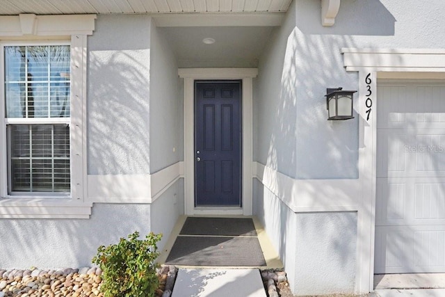 6307 113th Ter E, Parrish, FL 34219 - doorway to property with stucco siding