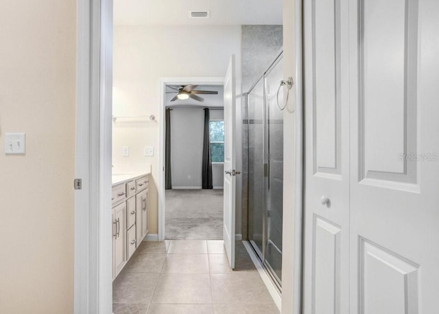 6307 113th Ter E, Parrish, FL 34219 - bathroom featuring a shower stall, ceiling fan, vanity, tile patterned floors, and baseboards