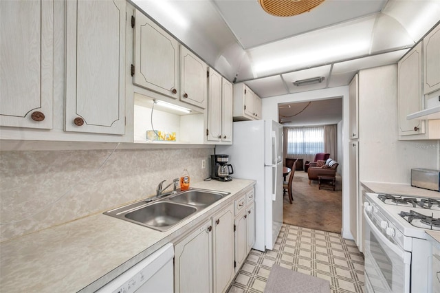 kitchen featuring white cabinetry, white appliances, sink, and decorative backsplash