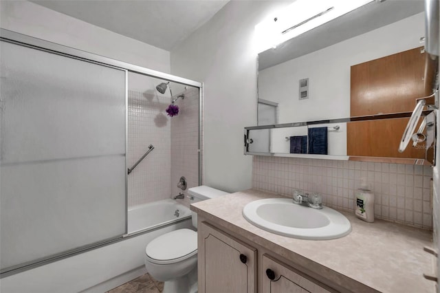 full bathroom featuring enclosed tub / shower combo, vanity, backsplash, and toilet