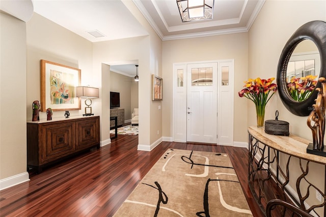 foyer featuring dark hardwood / wood-style flooring and ornamental molding