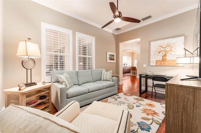 living room with dark hardwood / wood-style flooring, ceiling fan, and crown molding