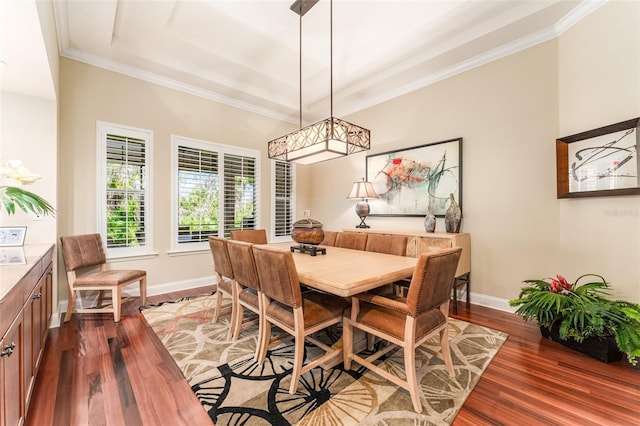 dining space with a raised ceiling, crown molding, and dark hardwood / wood-style flooring