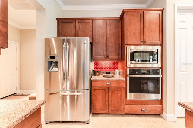 kitchen featuring crown molding, appliances with stainless steel finishes, and light stone countertops