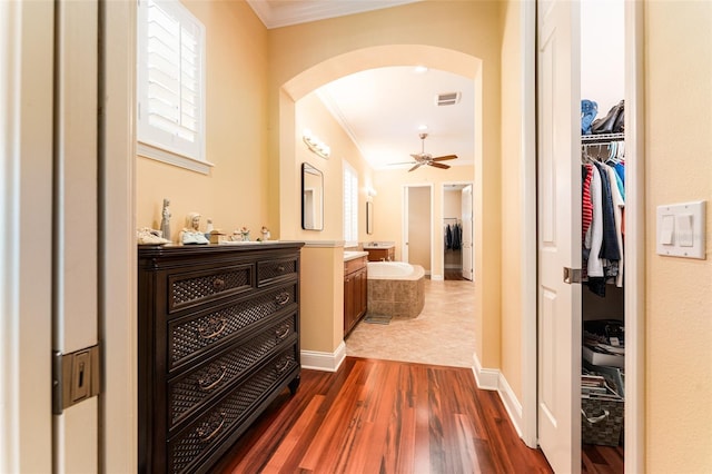 corridor featuring crown molding and dark hardwood / wood-style floors