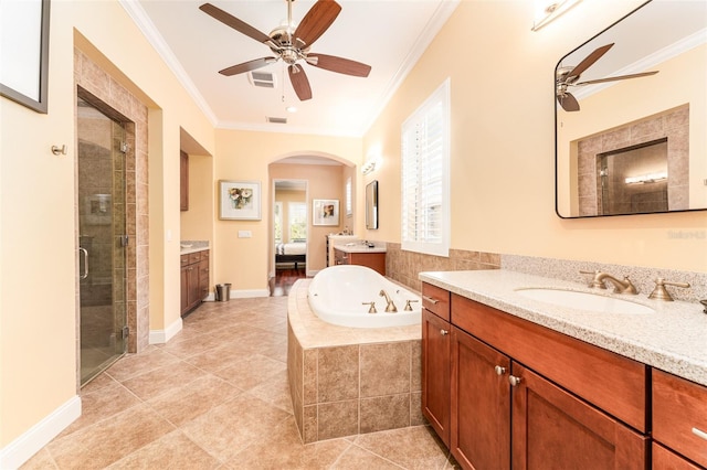 bathroom with tile patterned floors, separate shower and tub, ornamental molding, ceiling fan, and vanity