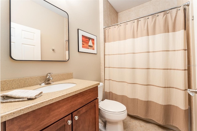 bathroom featuring toilet, vanity, tile patterned flooring, and curtained shower