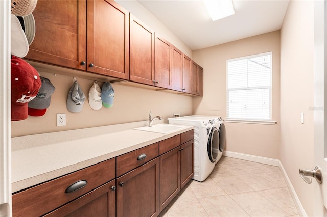 clothes washing area with sink, cabinets, independent washer and dryer, and light tile patterned floors