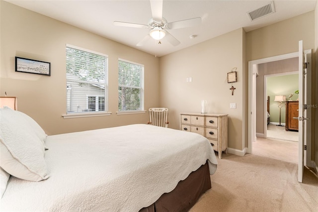 bedroom featuring light carpet and ceiling fan