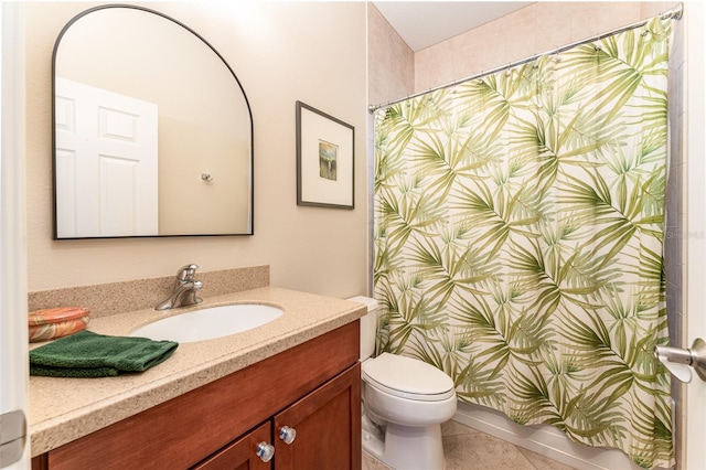 bathroom with toilet, tile patterned flooring, and vanity