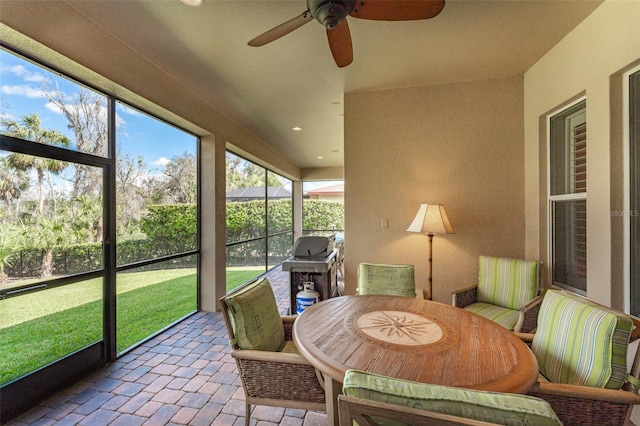 sunroom featuring ceiling fan