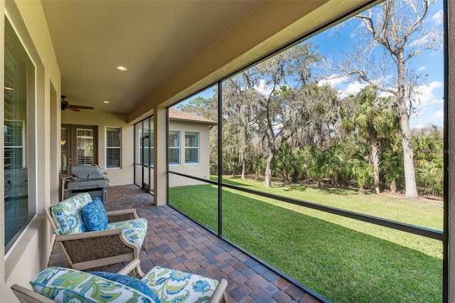 sunroom featuring ceiling fan