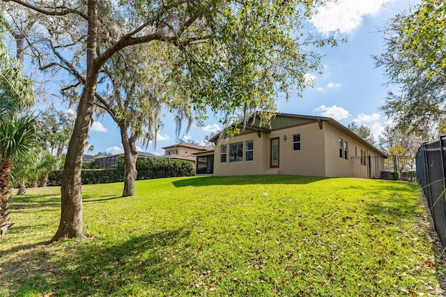 back of house featuring a lawn