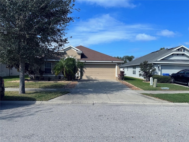 view of front of property featuring a garage and a front lawn