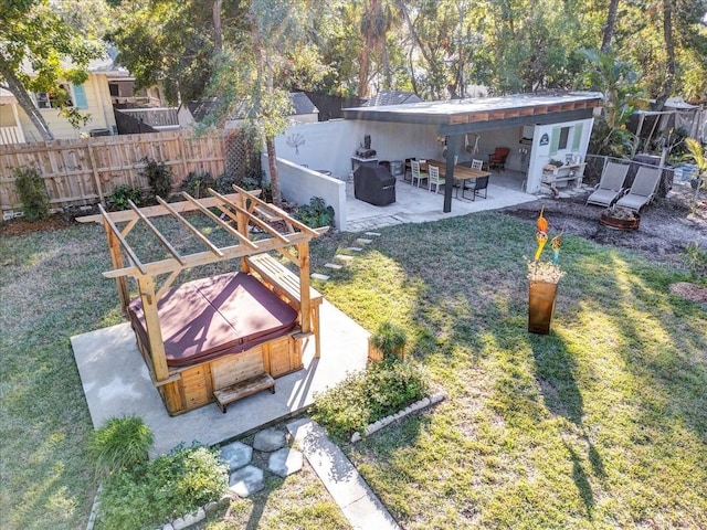 view of yard with a patio area and a hot tub