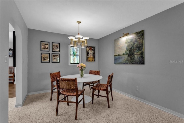 dining space with a chandelier