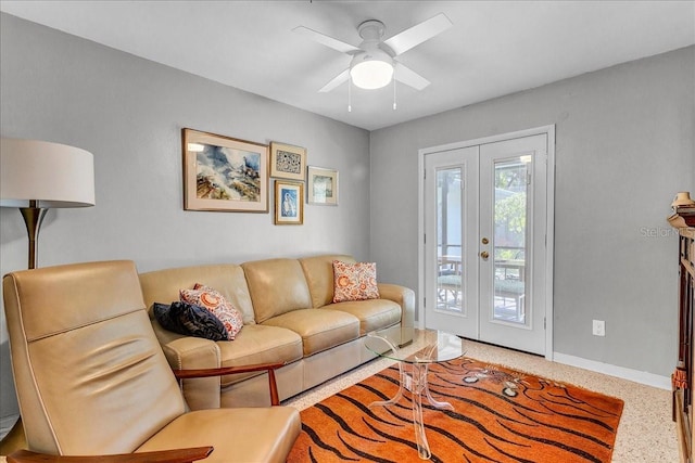 living room featuring ceiling fan and french doors