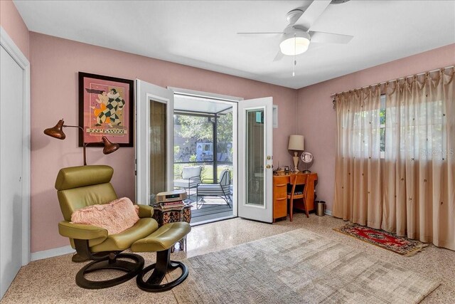 living area featuring plenty of natural light and ceiling fan