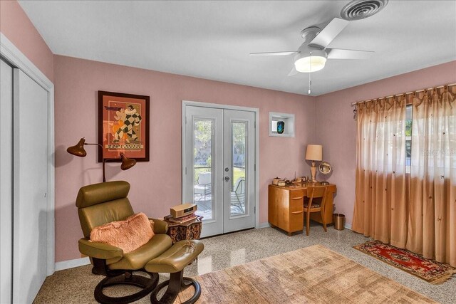 sitting room featuring ceiling fan and french doors