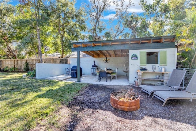 exterior space featuring an outdoor fire pit and a patio