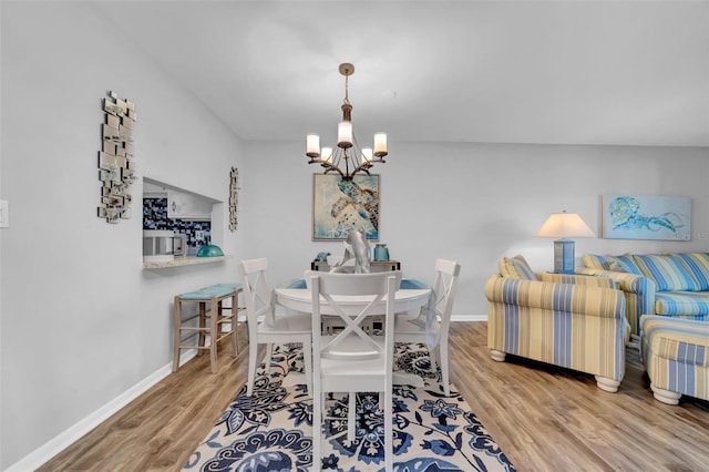 dining room featuring hardwood / wood-style floors and a notable chandelier