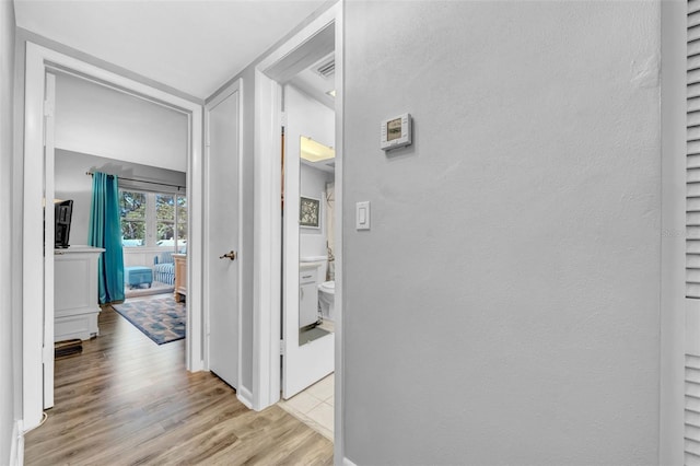 hall with light wood-type flooring